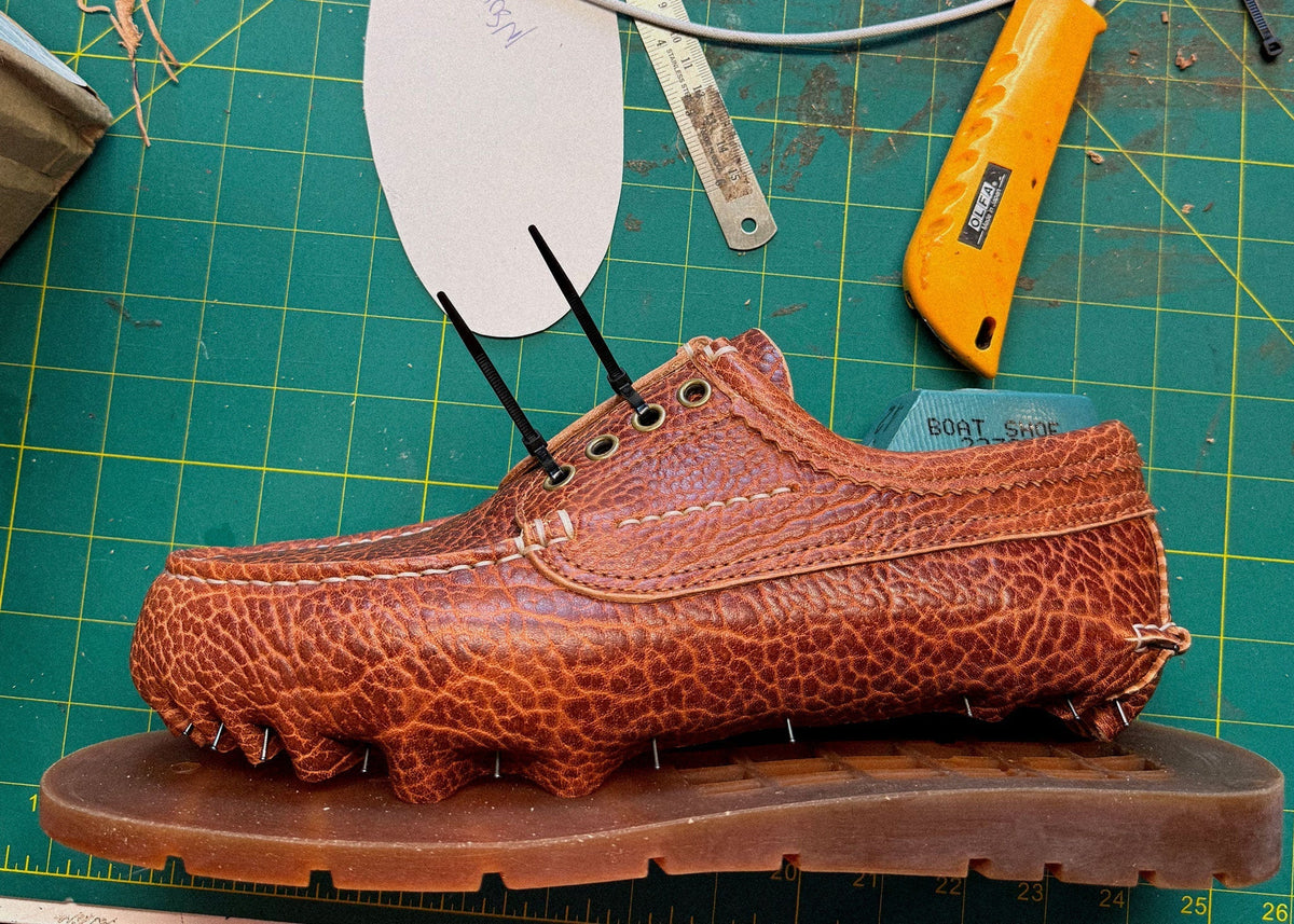 A Railtown Camp Moc upper in Horween Yellowstone horsehide, lasted on its sole on the workbench.