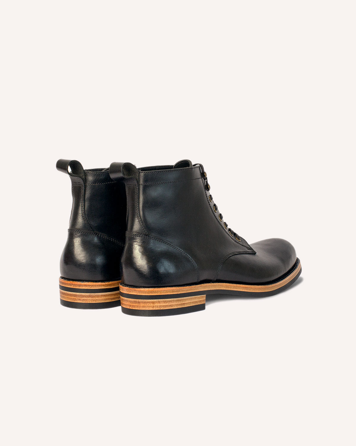 A pair of Derby Boots from Archive Leather Goods, in Black Horween Dublin leather; rear view of the heel counters.