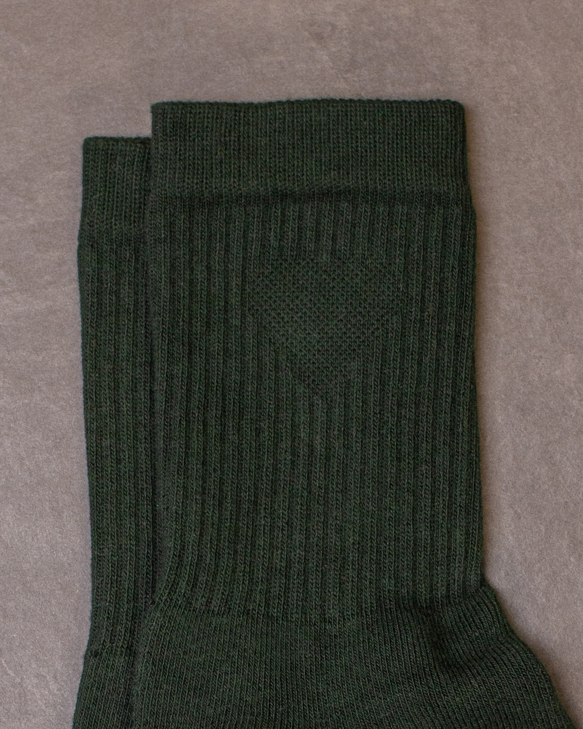 Close-up of a pair of Foundation Socks from Archive Leather Goods in Salal (dark green).
