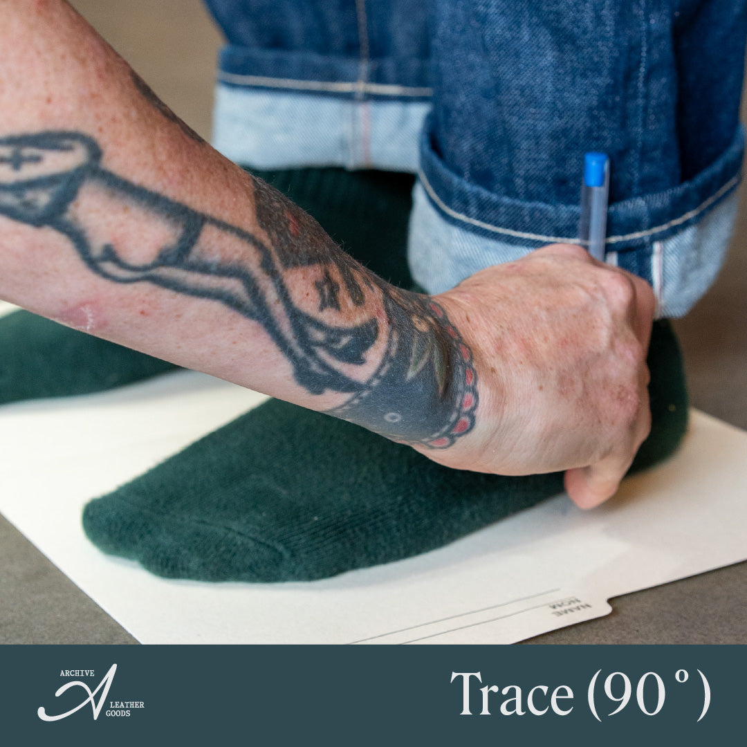 Measurement step: tracing around the foot with the pen held upright at 90 degrees.