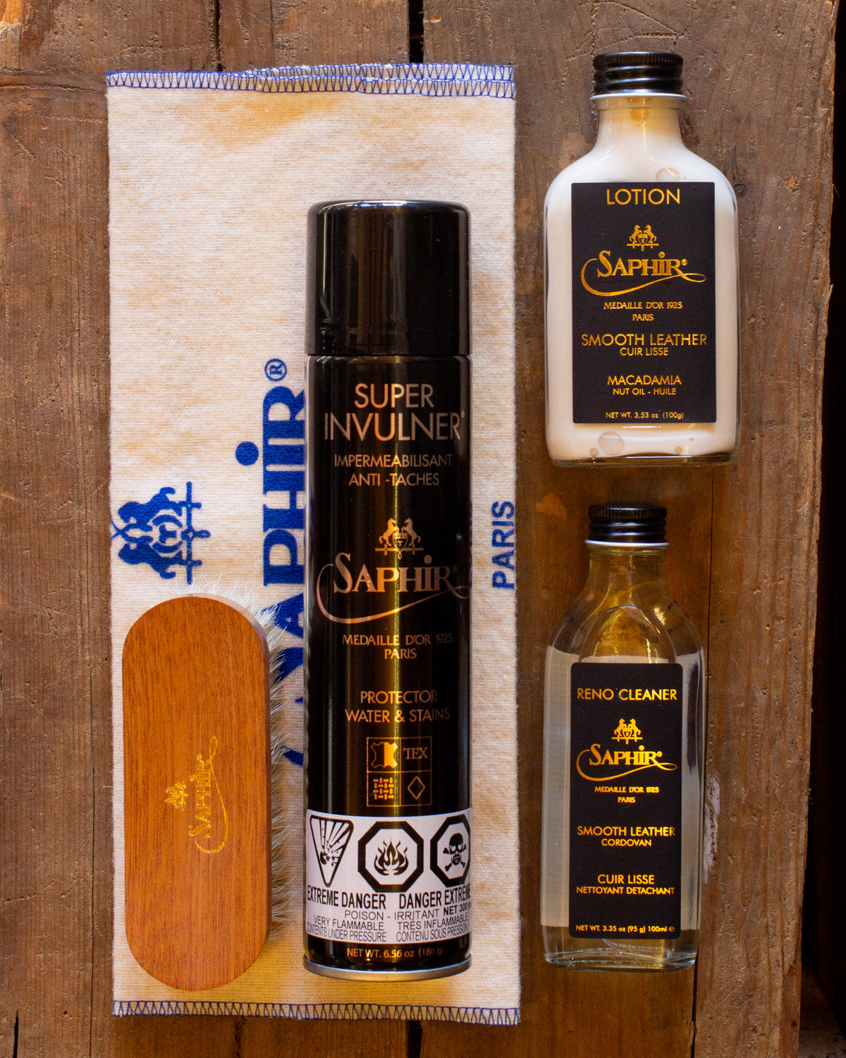 Leather Care Kit from Archive Leather Goods: cleanser, conditioner, brush, cloth and protectant; top down view.
